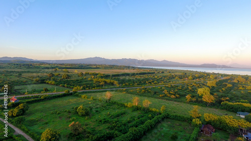 Aerial panoramic View of a scenic Highway surrounded green field Landscape during a summer morning
