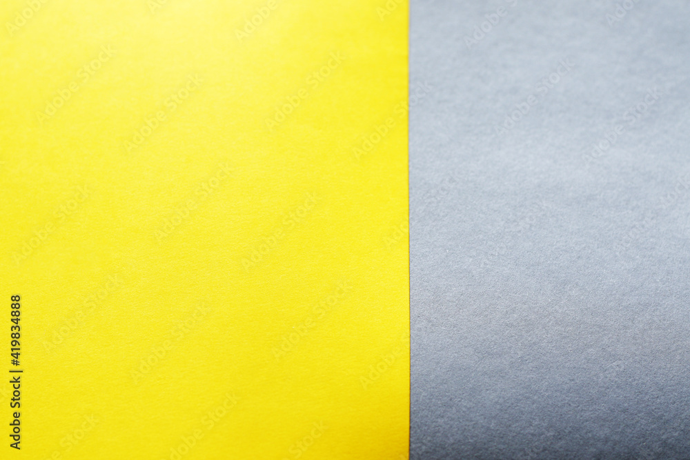 empty illuminate yellow and grey paper background. colour trend of the year 2021 empty illuminate yellow and grey paper background. colour trend of the year 2021