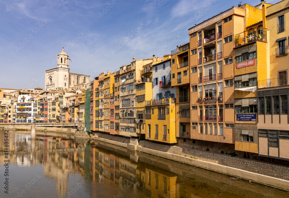 the historic old city center of Girona in northern Spain with ist many colorful buildings along the banks of the Onyar River