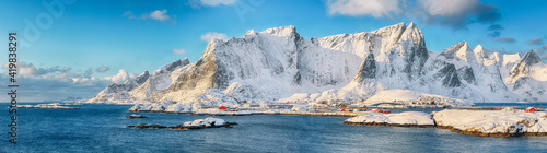 Fabulous winter view of Reine and Sakrisoya villages seen from Hamnoy and snowy mountaines in background .