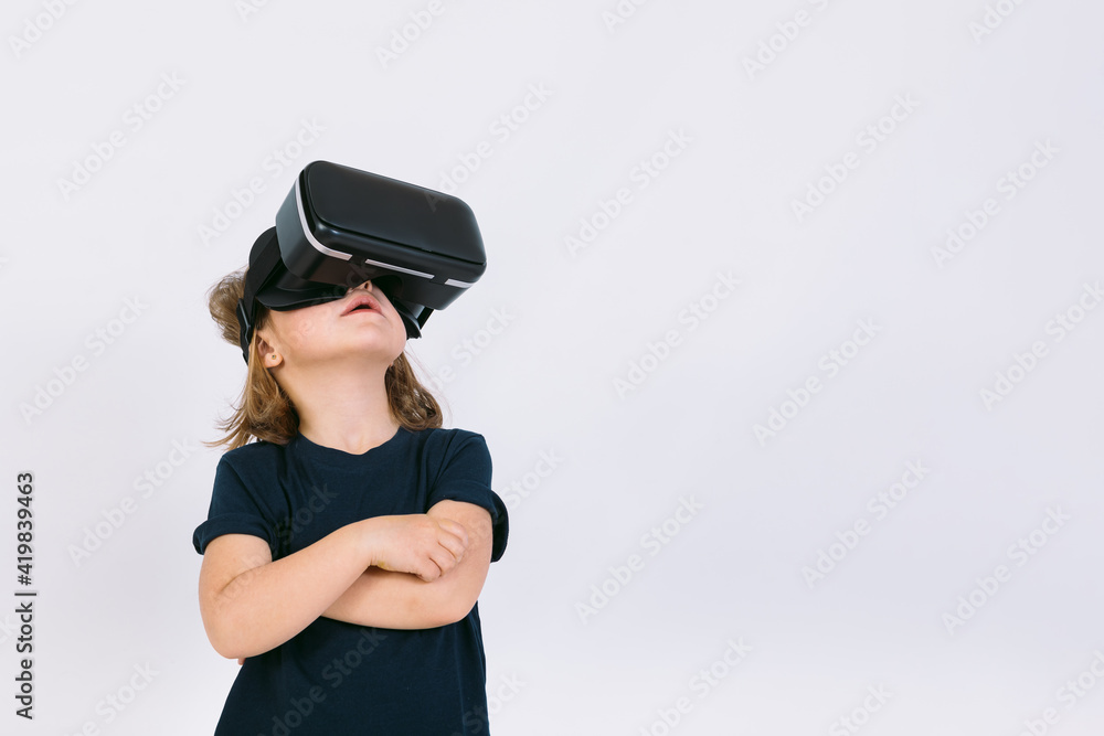Little girl with virtual reality glasses looking up on white background Little girl with virtual reality glasses looking up on white background