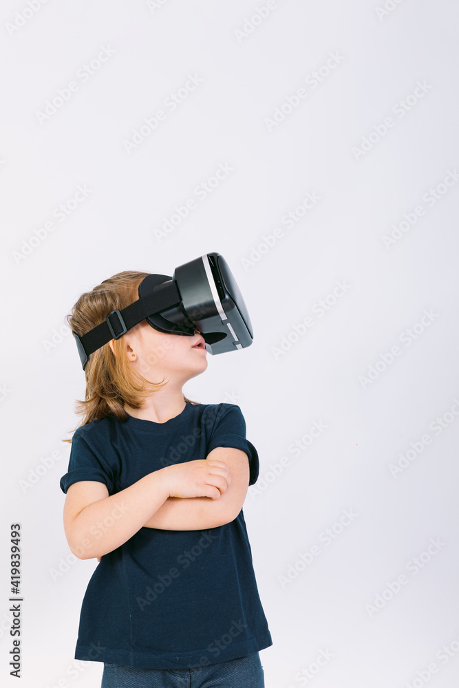 Little girl with virtual reality glasses looking up on white background Little girl with virtual reality glasses looking up on white background