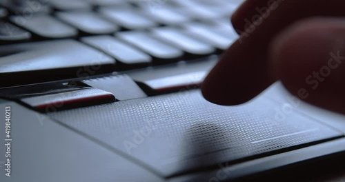 Man hand using touchpad and buttons on laptop computer. IT technology function, device operation control and user interface conception