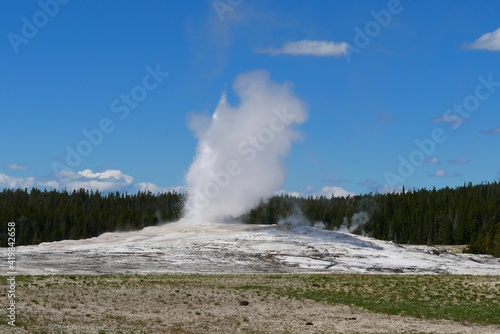 Eruption Old Faithful geyser at Yellowstone National Park, Wyoming, United States