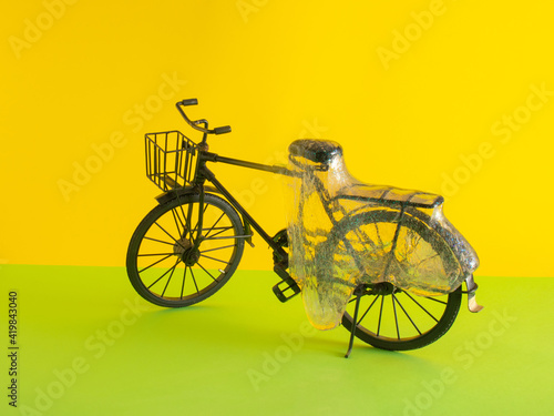 black old retro vintage bike and slime on sunny yellow and light green background. Minimal creative abstract concept.