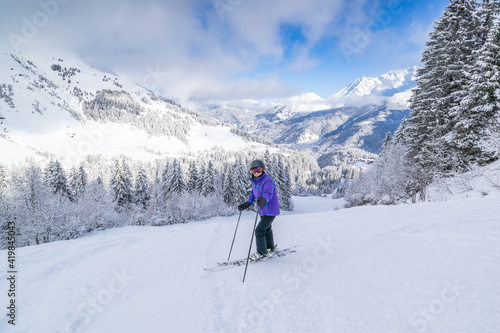 A lone skier high up in the French Alps near the pretty French Alpine village of Les Contamines-Montjoie