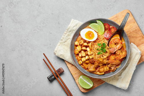 Photography Laksa in gray bowl on concrete table top
