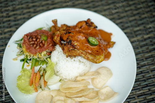 Ayam Taliwang food, special food is young smoked chicken, spiced and then burned, and chili or plecing water spinach. Indonesia food
 photo