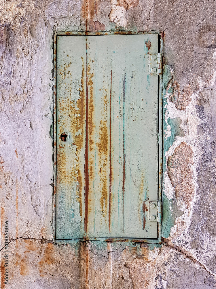 old textured and weathered green metal door old textured and weathered green metal door
