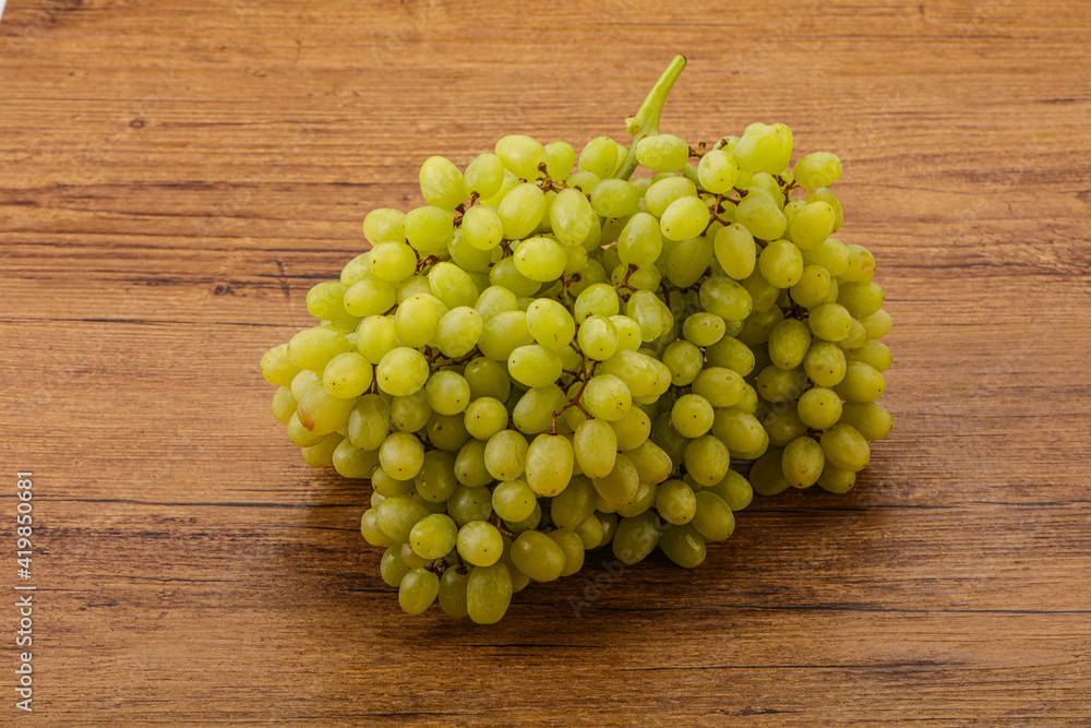 Green grape branch over background Green grape branch over background