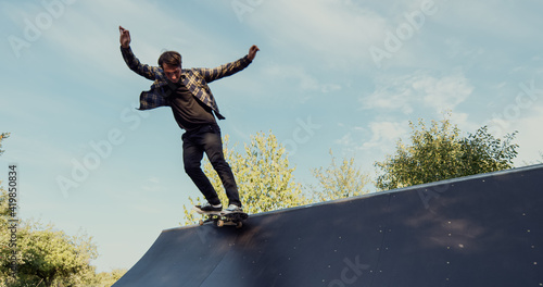 Принти на полотні Young male adult skateboarding halfpipe miniramp grinding and makes tricks