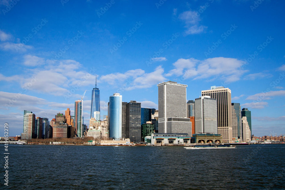 Office buildings and skyscrapers on the coastline of  Lower Manhattan , New York, USA. sunny  day with blue sky.