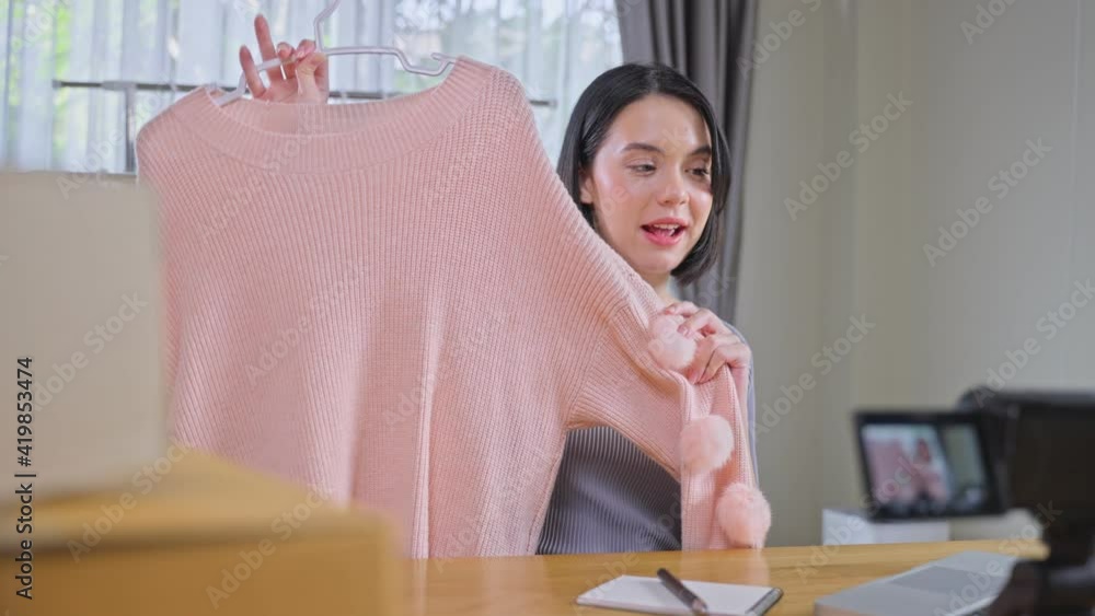 Asian young beautiful girl selling clothes online by live streaming. Asian young beautiful girl selling clothes online by live streaming.