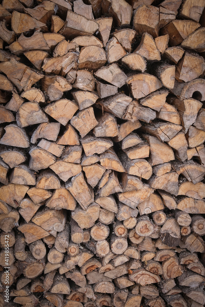 Wooden background in the form of chopped and stacked logs. Wooden texture. Wooden background in the form of chopped and stacked logs. Wooden texture.