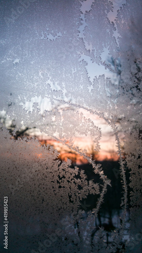 ice flowers on the window. very low temperatures in the morning during the winter season. traces of frost on the glass