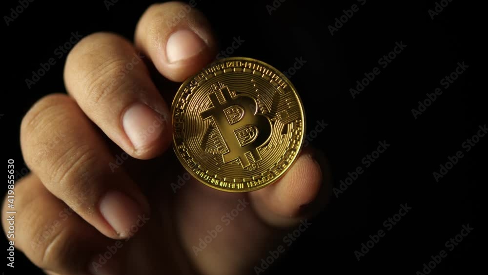 Close up shot of hand holding golden bitcoin on black blurred background. Bitcoin coins technology, bitcoin mining concept,Crypto currency, bitcoin BTC, Blockchain technology.
Close up shot of hand holding golden bitcoin on black blurred background. Bitcoin coins technology, bitcoin mining concept,Crypto currency, bitcoin BTC, Blockchain technology.