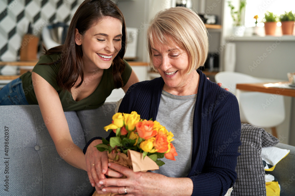 Daughter giving flowers to her mother Daughter giving flowers to her mother