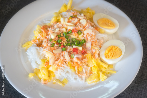 Thai rice noodles with pineapple and coconut milk the delicious of traditional food served on white plate in Thai name is Kanom Cheen Saw Num. photo