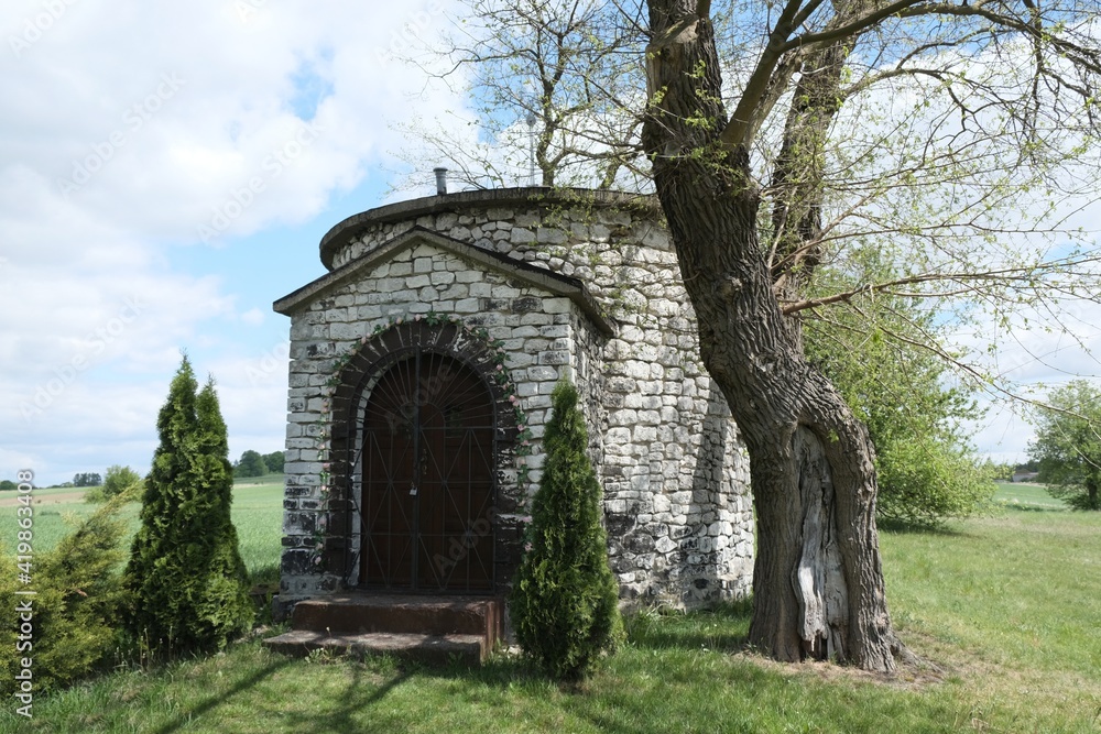 Historic stone chapel of Saint Giles among fields in village of Zrebice, Jura Krakow - Czestochowa, Poland Historic stone chapel of Saint Giles among fields in village of Zrebice, Jura Krakow - Czestochowa, Poland