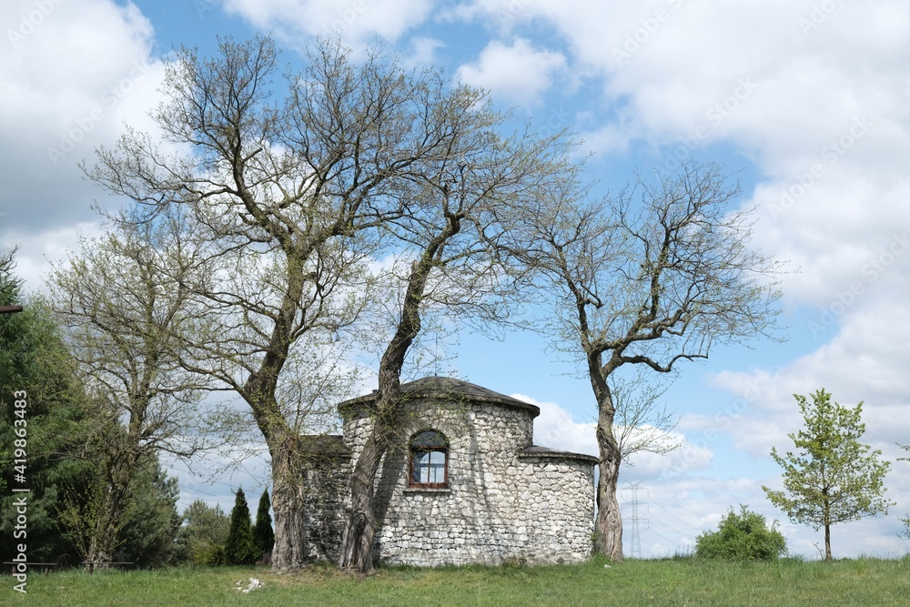 Historic stone chapel of Saint Giles among fields in village of Zrebice, Jura Krakow - Czestochowa, Poland