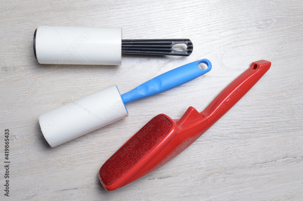 brushes for cleaning clothes. sticky and a bristled brush, lie on a light-colored countertop. brushes for cleaning clothes. sticky and a bristled brush, lie on a light-colored countertop.