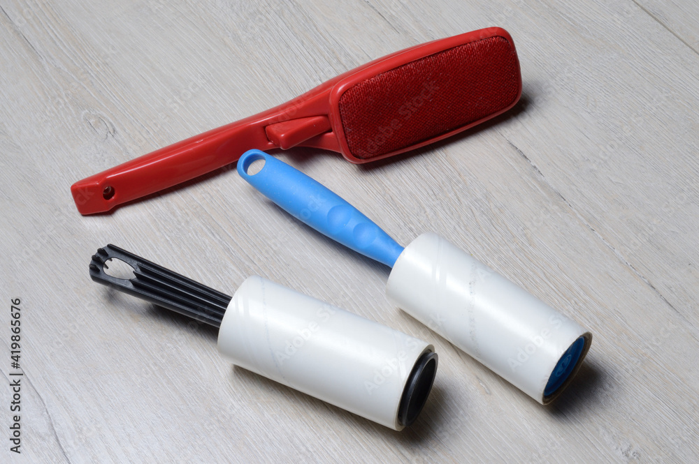 brushes for cleaning clothes. sticky and a bristled brush, lie on a light-colored countertop. brushes for cleaning clothes. sticky and a bristled brush, lie on a light-colored countertop.