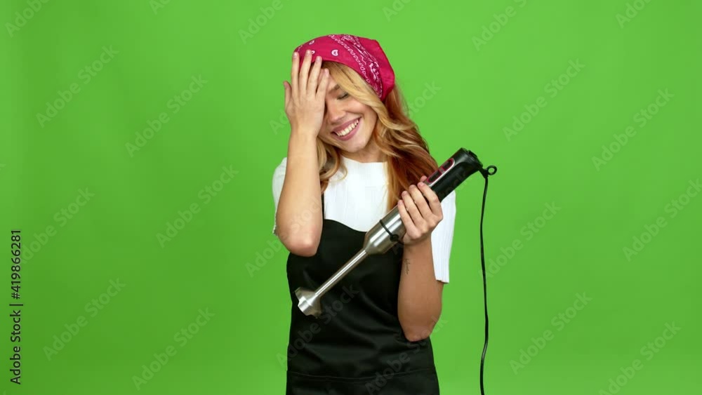 Young blonde girl using hand blender intending to realizes the solution while lifting a finger up over isolated background on green screen chroma key Young blonde girl using hand blender intending to realizes the solution while lifting a finger up over isolated background on green screen chroma key