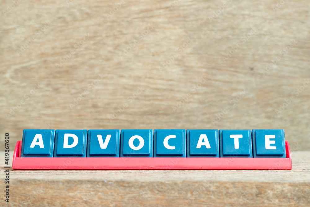 Obraz premium Tile alphabet letter with word advocate in red color rack on wood background