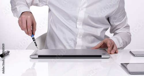 Service worker opening laptop case in white walled lab 