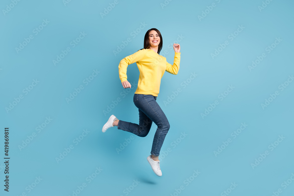Full size photo of nice optimistic brunette long hairdo lady run wear shirt jeans sneakers isolated on blue color background