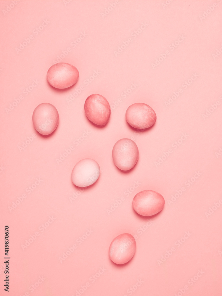 Creatively painted eggs in pastel colors on pink background. Happy Easter concept. Flat lay.