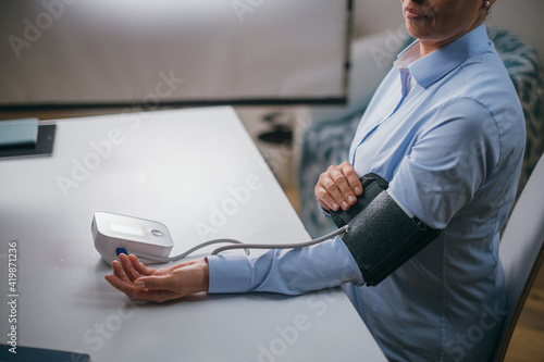 Hands with a tonometer on the table