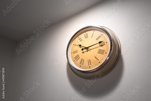 Wallpaper Mural A classic round clock with roman numbers which is installed on white plain wall. Interior decoration object photo. Torontodigital.ca