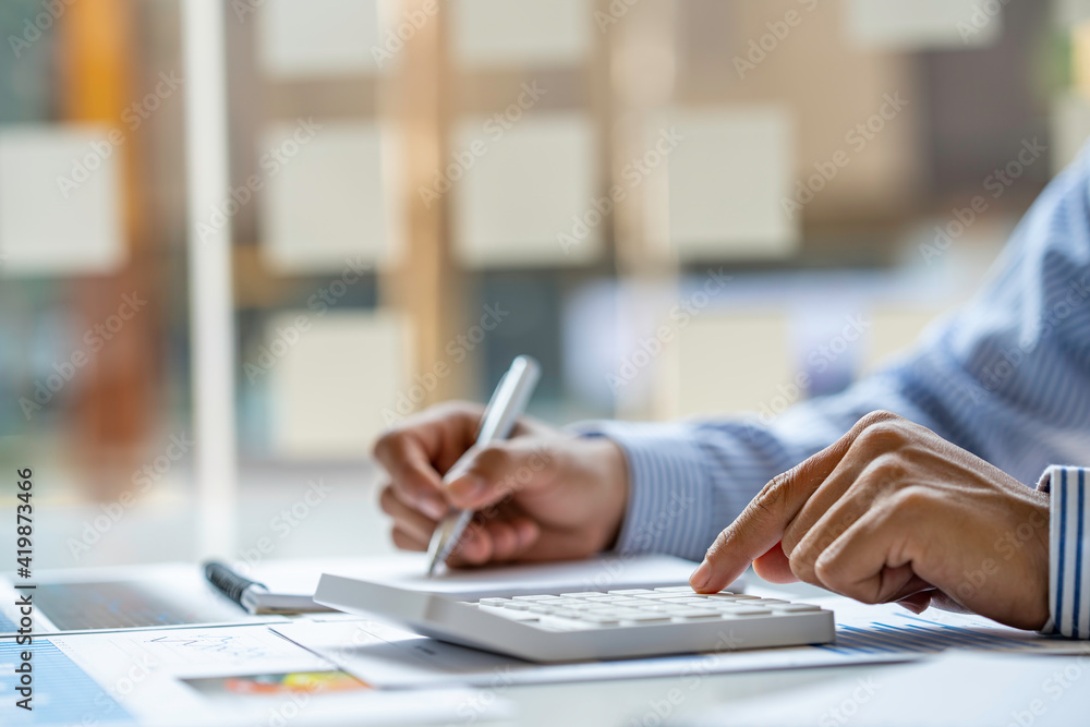 Close up of male accountant or banker making calculations. Savings money, Annual tax calculation finances, and economy concept. Financial calculation concept Close up of male accountant or banker making calculations. Savings money, Annual tax calculation finances, and economy concept. Financial calculation concept