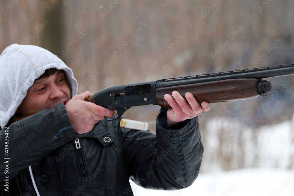 The man is shooting with a shotgun The man is shooting with a shotgun