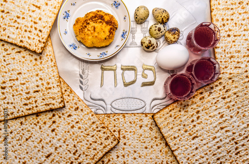 Pesah celebration concept (Jewish Passover holiday). Top view on traditional food and drink attributes. Hebrew letters, in English translation mean as Jewish Passover photo