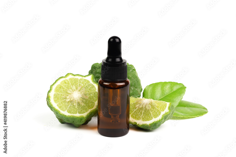 Bergamot oil in bottle and fresh bergamot fruit with green leaf isolated on white background. Bergamot oil in bottle and fresh bergamot fruit with green leaf isolated on white background.