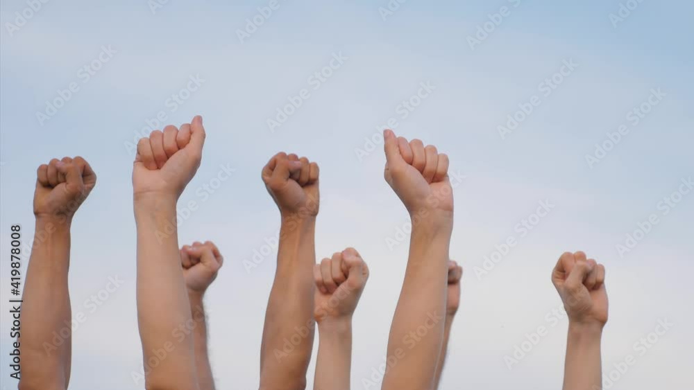 Teamwork. A group of people against the sky raises their hands up. The concept of voluntary voting, expression of consent, support for democracy. Teamwork. A group of people against the sky raises their hands up. The concept of voluntary voting, expression of consent, support for democracy.