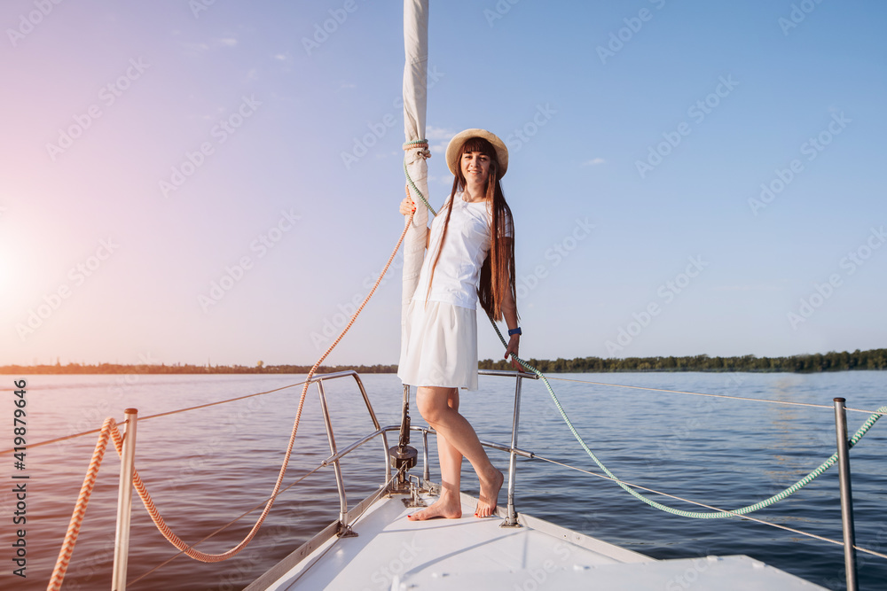Woman in white wear staying on sailboat