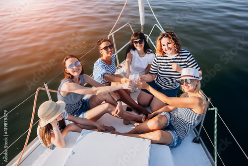 summer holidays and vacation - girls with champagne glasses on boat or yacht © VlaDee