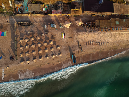 Aerial view of amazing beach with umbrellas and turquoise sea at sunrise. Black Sea at Vama Veche, Romania photo