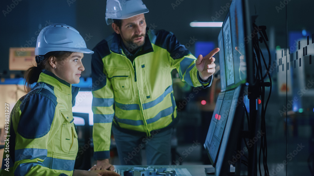 Industry 4.0 Modern Factory: Project Engineer Talks to Female Operator who Controls Facility Production Line, Uses Computer with Screens Showing AI, Machine Learning Enhanced Assembly Process Industry 4.0 Modern Factory: Project Engineer Talks to Female Operator who Controls Facility Production Line, Uses Computer with Screens Showing AI, Machine Learning Enhanced Assembly Process