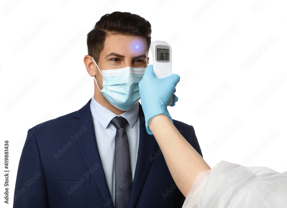 Doctor measuring man's temperature on white background, closeup. Prevent spreading of Covid-19 Doctor measuring man's temperature on white background, closeup. Prevent spreading of Covid-19