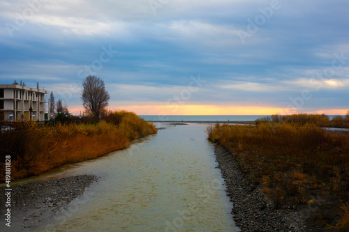 Wallpaper Mural The river flows into the sea. View of the riverbed of the Mzymta River, which flows into the Black Sea, Adler district of Sochi, Russia. mountain river flowing to the sea Torontodigital.ca