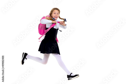 Happy schoolgirl running with backpack