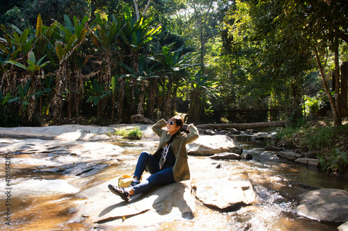 Travelers thai women people travel visit Mae sa waterfalls and rest relax outdoor in jungle wild forest in morning of doi suthep doi pui national park at Mae On city in Chiang Mai, Thailand photo