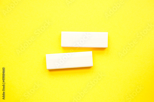 Stack wooden blocks on a yellow background