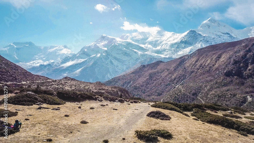 A mountain chain in the Himalayas that is covered with snow. This is a hiking trail of the Annapurna circuit.