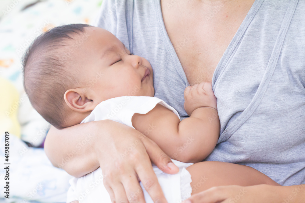 mother carried baby after the feeding.mother carried baby after the feeding. mother carried baby after the feeding.mother carried baby after the feeding.