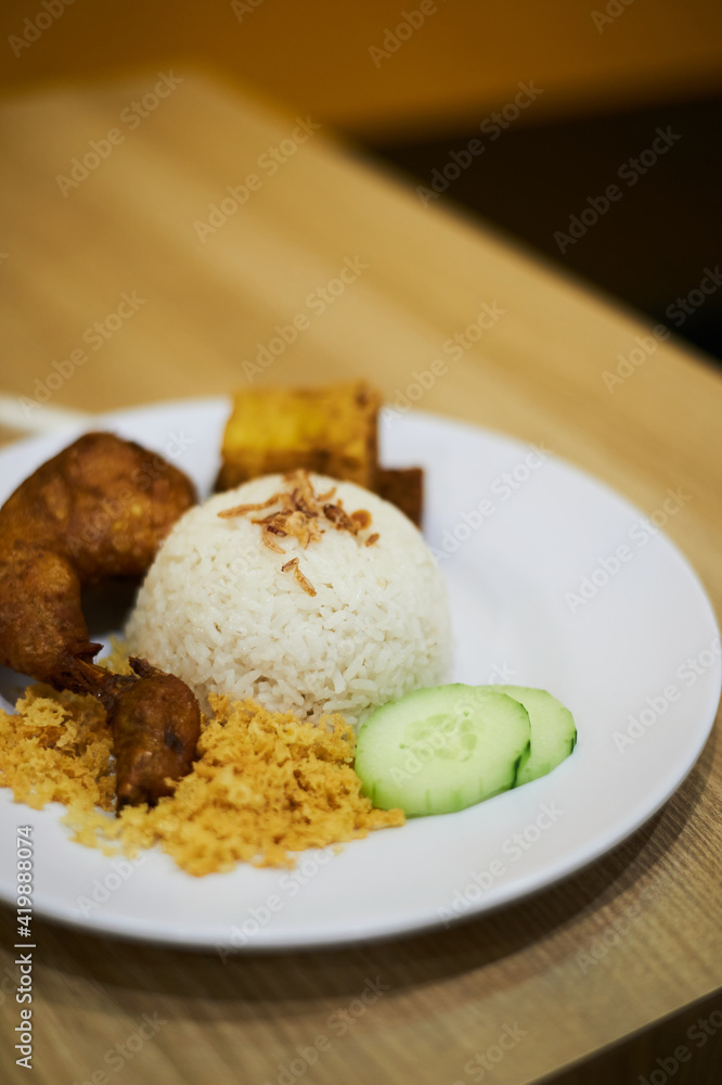 A Plate of  chicken with nasi uduk